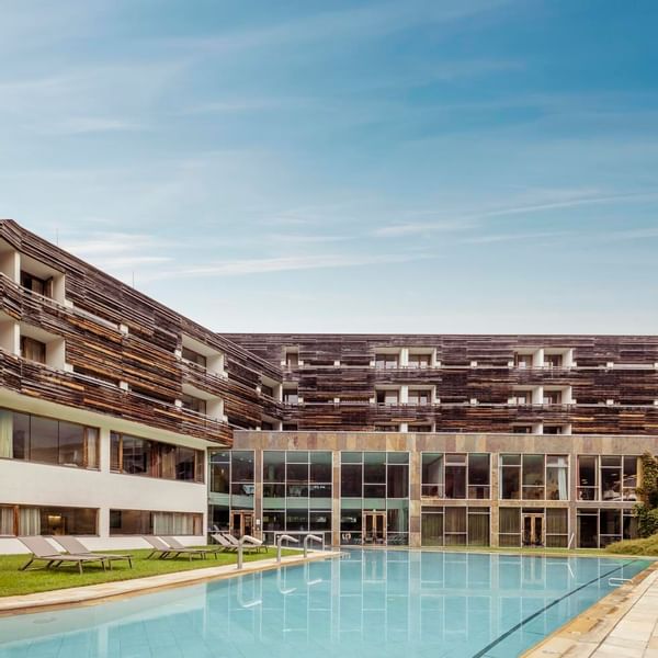 Low-angle view of a building and pool area at Falkensteiner Hotel & Spa Carinzia