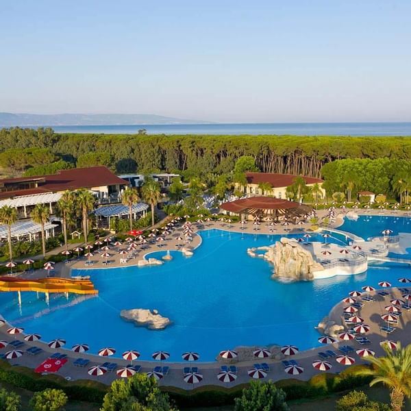 Aerial view of the pool area by forest at Falkensteiner Club Funimation Garden Calabria
