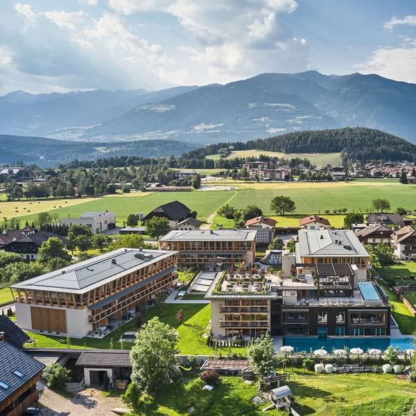Aerial view of Falkensteiner Hotel Kronplatz with mountain backdrop