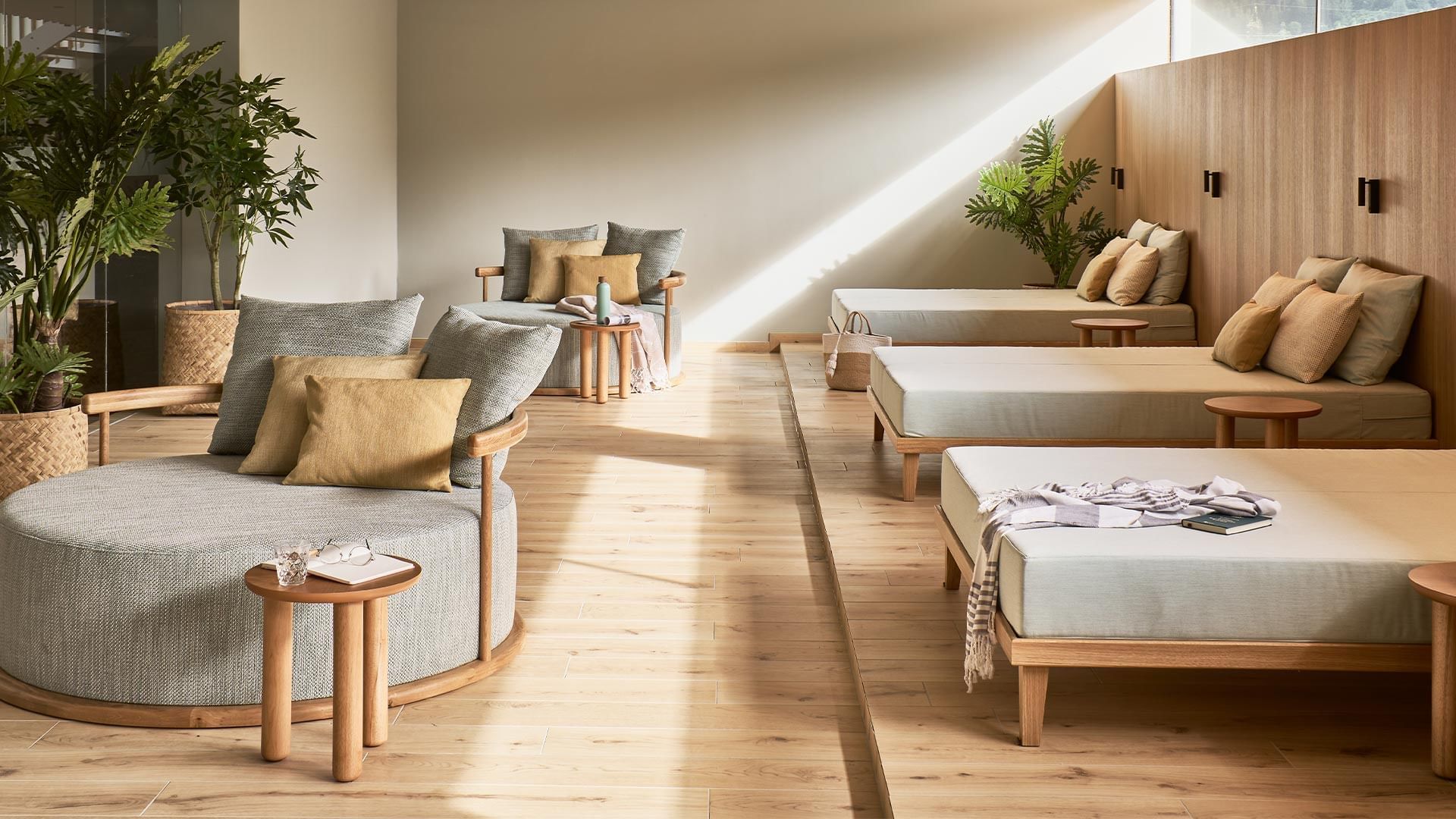 Sitting area with comfy lounges and beds at Falkensteiner Hotel & Spa Carinzia