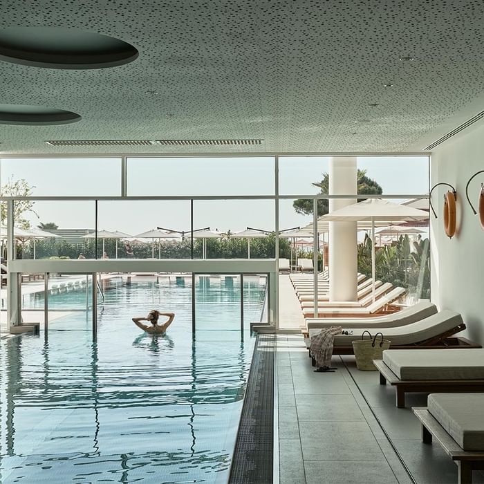 In- and Outdoor pools with loungers in Acquapura Blue Horizon Spa at Falkensteiner Hotel & Spa Jesolo