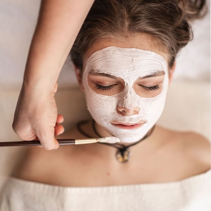 A lady having a face mask at Falkensteiner Hotels & Residences