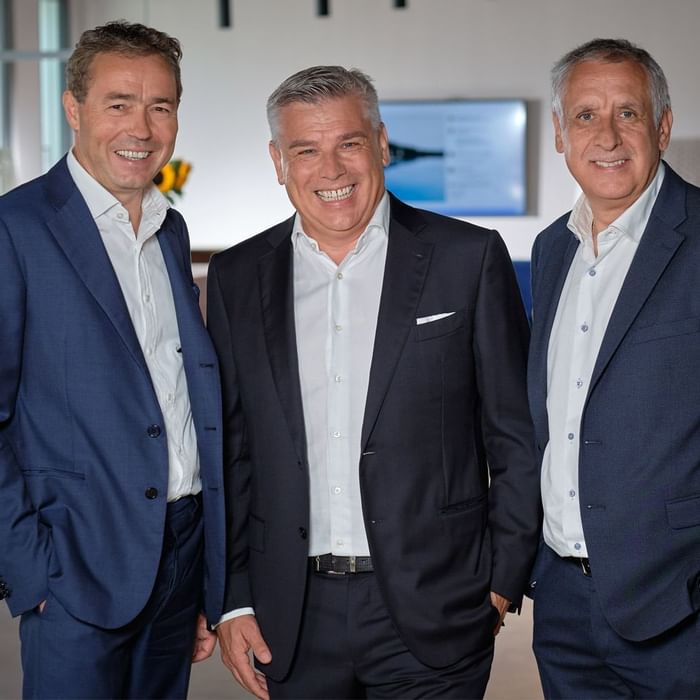 Three management members posing for a photo at Falkensteiner Hotels Crowdinvesting