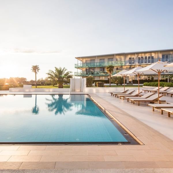 Sunbeds lined by the outdoor pool area at Falkensteiner Residences Senia