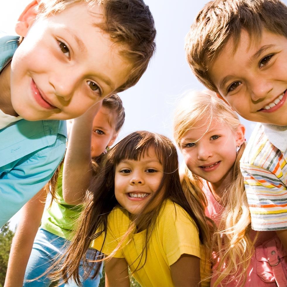 Group of children outdoors wearing colorful clothing at Falkensteiner Hotels & Residences