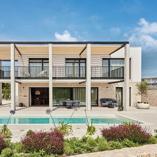 Exterior front view of a villa with outdoor pool at Falkensteiner Luxury Villas Punta Skala