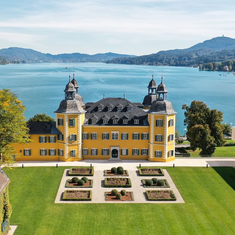 Distance exterior of the hotel building overlooking the sea at Falkensteiner Schlosshotel Velden