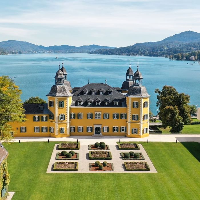 Distance exterior of the hotel building overlooking the sea at Falkensteiner Schlosshotel Velden