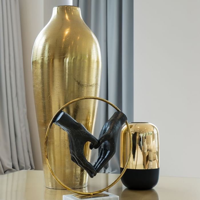 Close-up of gold plated decorative items on a table at Falkensteiner Hotels & Residences