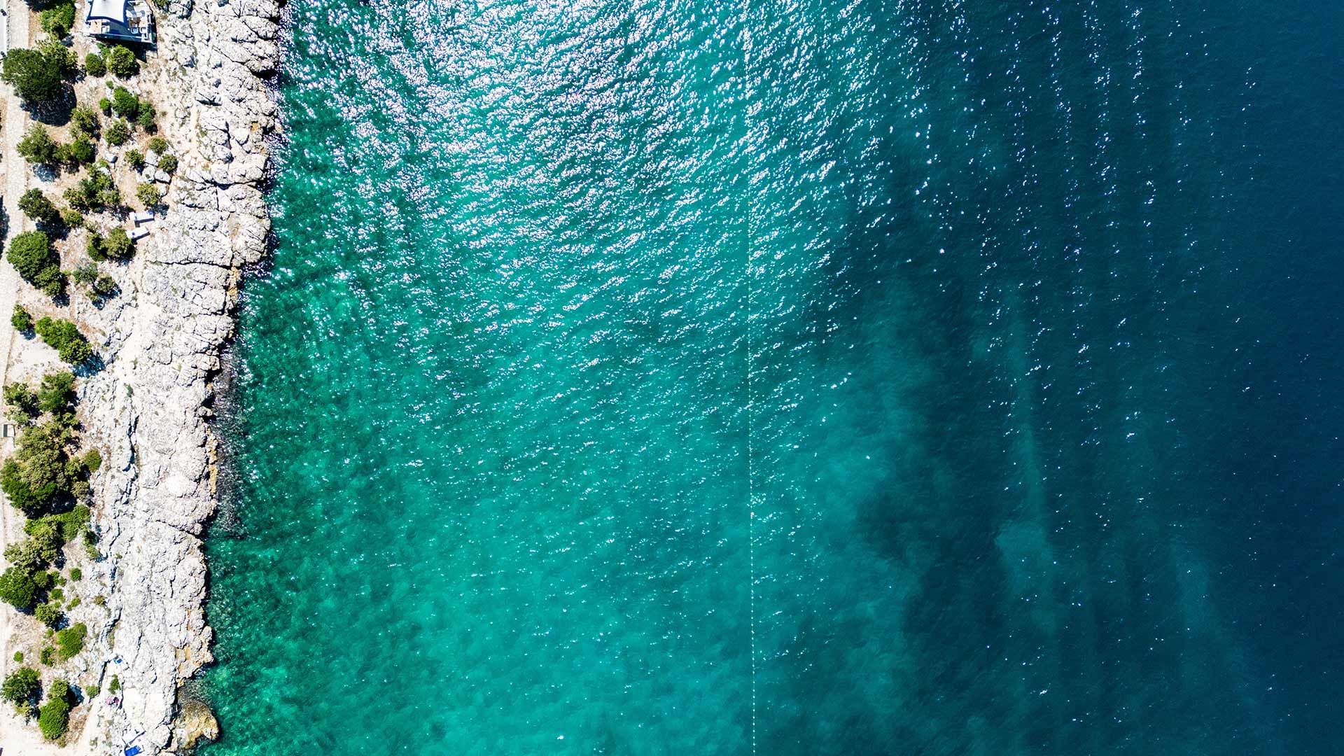 Birds-eye view of the deep sea with the beach near Falkensteiner Hotels & Residences